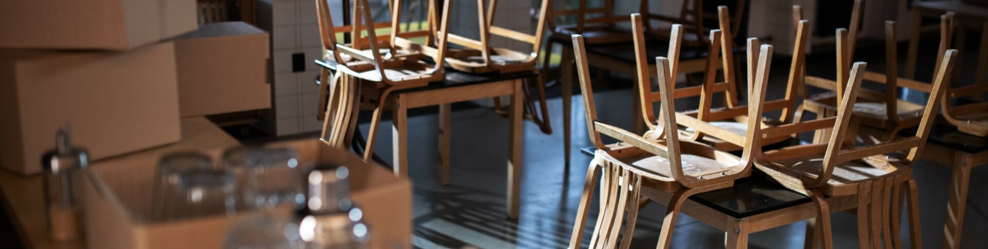 Packed boxes in closed cafe, small business lockdown due to coronavirus.
