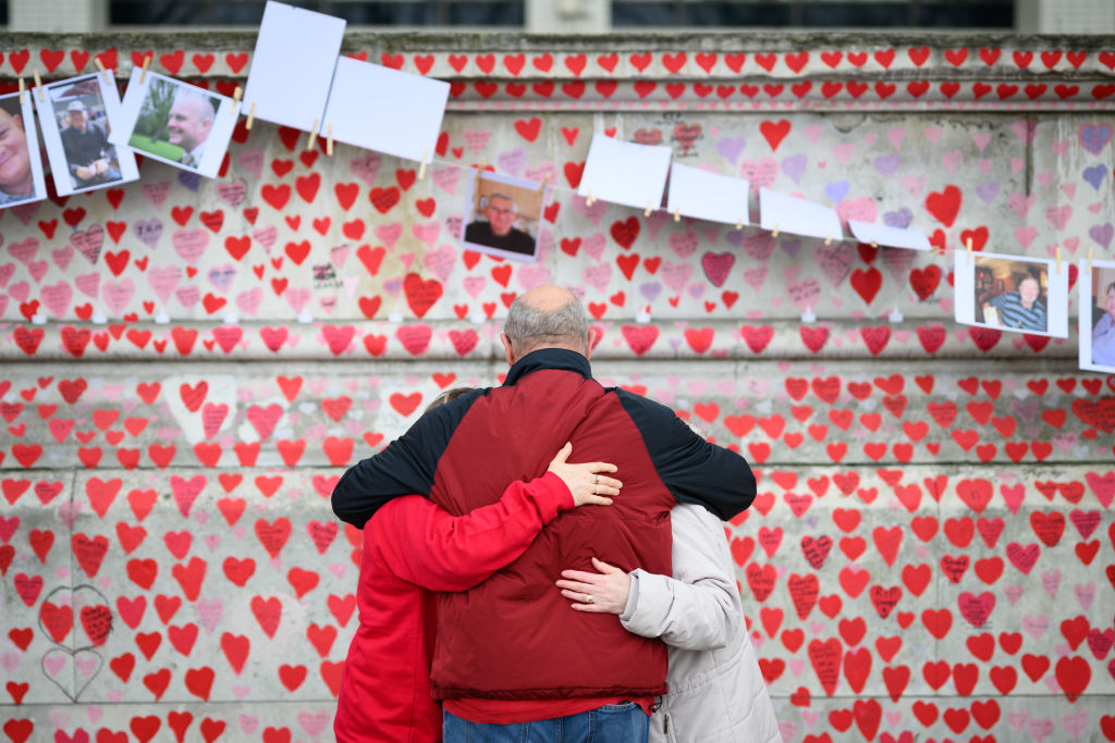 Families look at the Covid Memorial Wall in central London. Credit: Getty